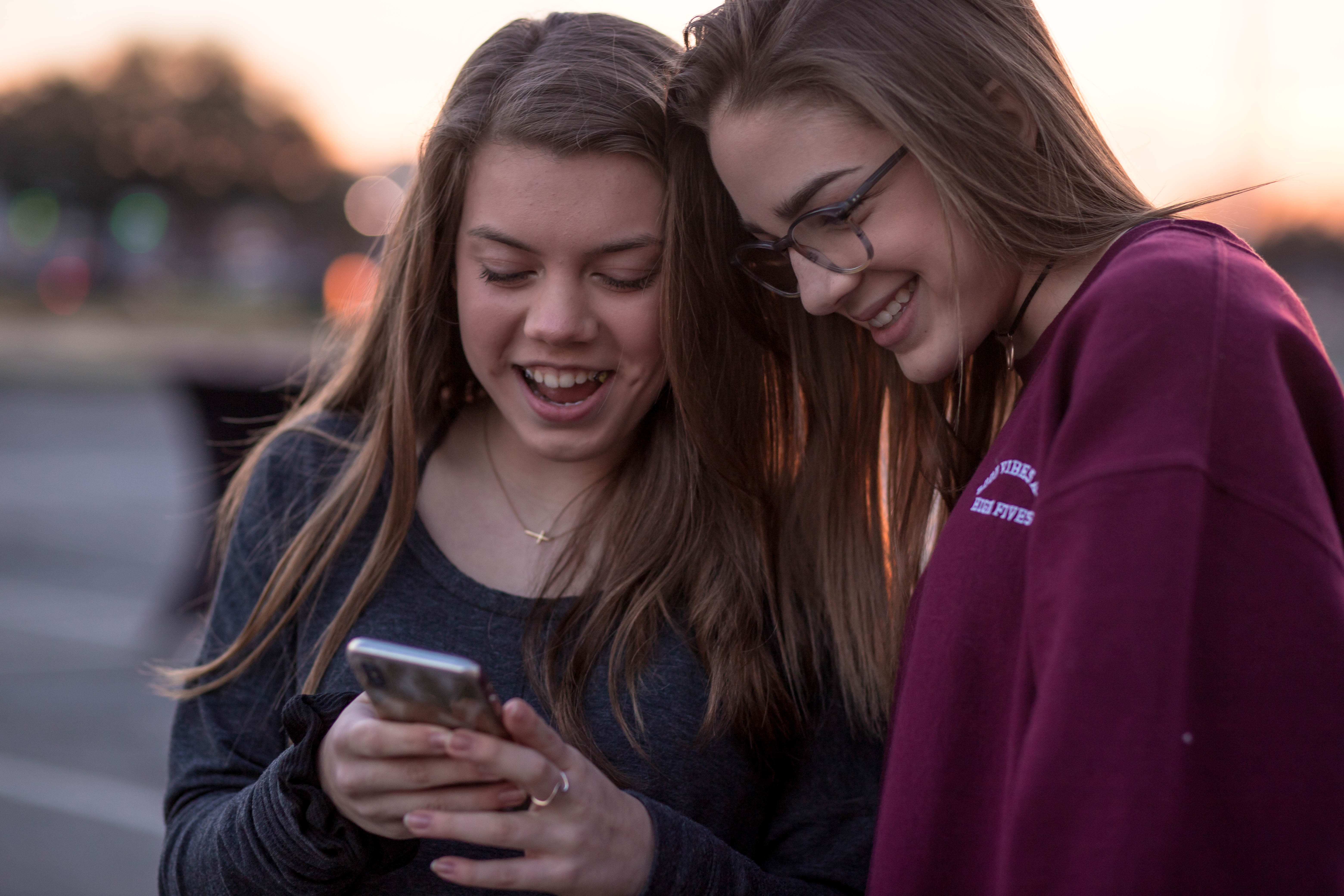 girls looking at phone